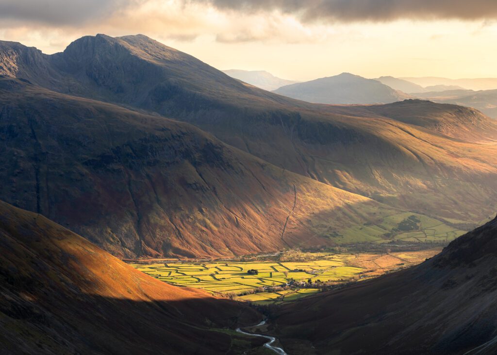A golden sunset over the Scafell range in the Lake District during a traditional Christmas hike to Pillar.