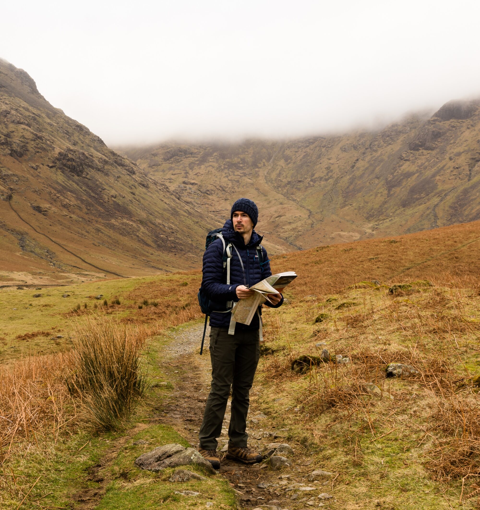 A portrait of landscape photographer Simon Evans as he stands in the breathtaking Mosedale Valley in the Lake District.