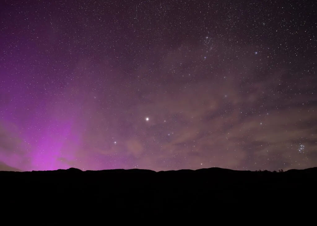 Landscape photograph of the Northern Lights over Lingmoor Fell in the Lake District during a summer's night.