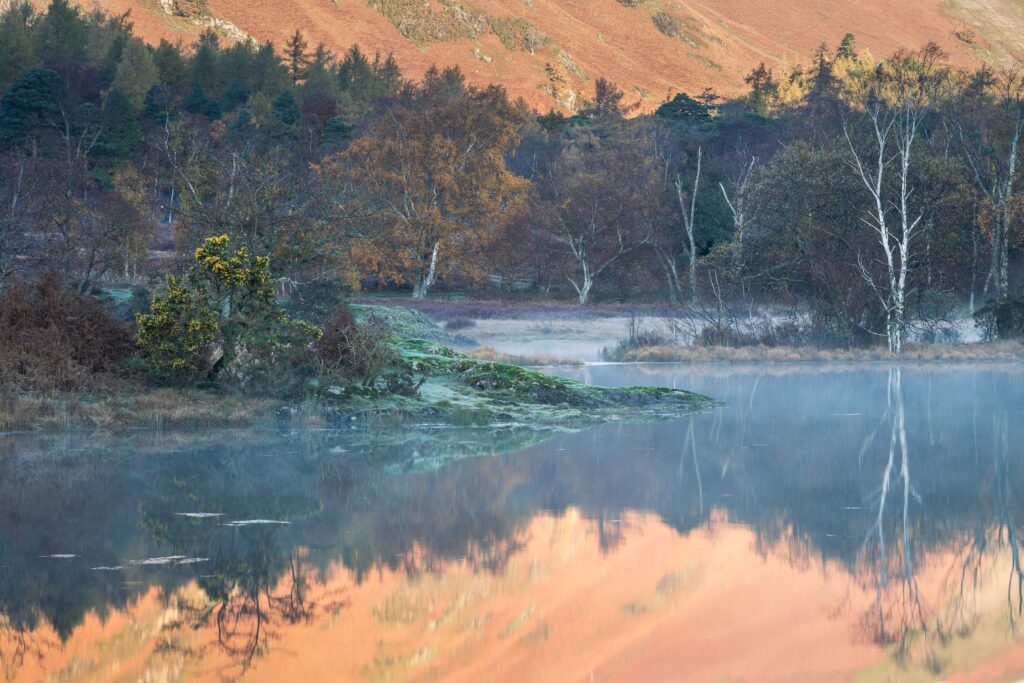 Beautiful reflections across Derwentwater during a calm autumnal morning