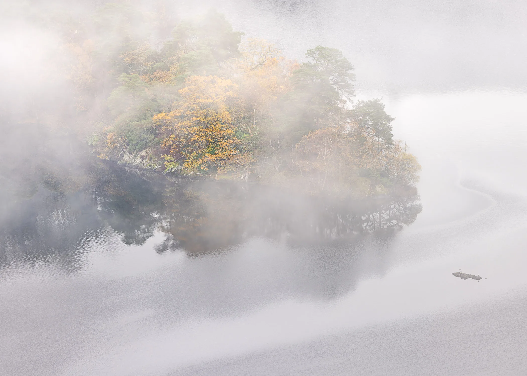Hero Island on Rydal Water, photographed from Loughrigg Fell on a misty autumnal morning.