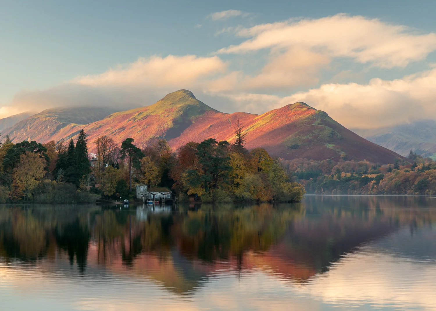A spectacular sunrise over Catbells and Derwent Island during peak autumn in the Lake District.
