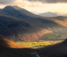 A golden sunset over the Scafell range in the Lake District during a traditional Christmas hike to Pillar.