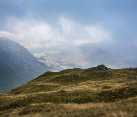 Lake District landscape photography from Bowfell during blue hour near The Band. Mickleden Valley is briefly visible during a gap in the clouds during the later stages of blue hour.