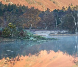 Beautiful reflections across Derwentwater during a calm autumnal morning