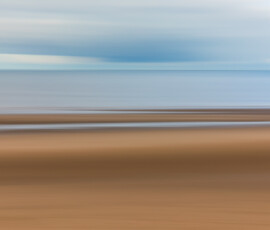 When the conditions don't favour wide-angle landscape photography, try Intentional Camera Movement (ICM). Intentional camera movement of a section of Formby Beach featuring sand, sea, and a cloudy sky.